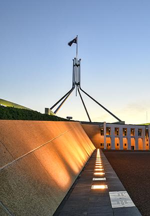 Parliament House and flagpole on dusk